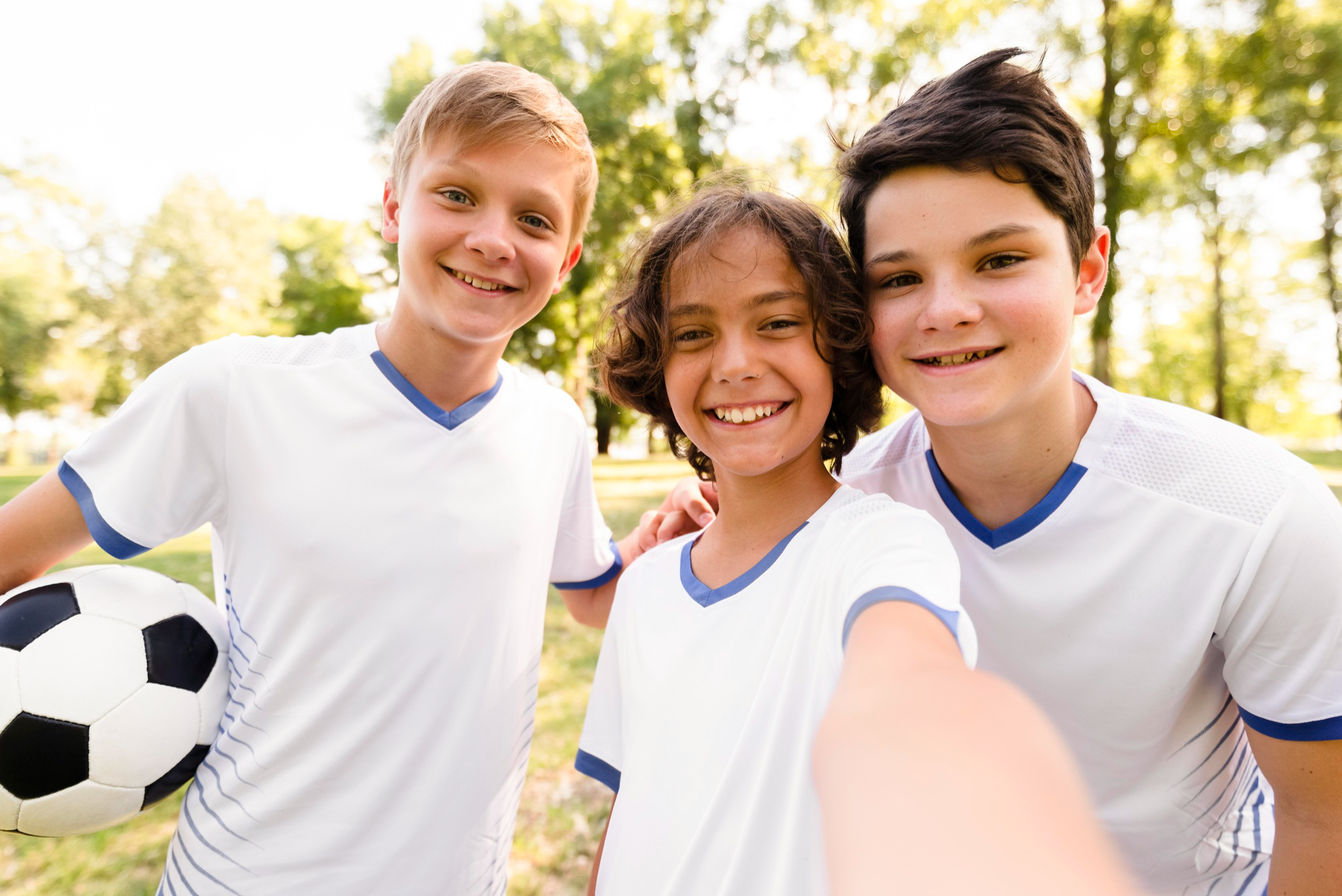 smiling boys taking soccer team selfie smiling boys taking soccer team selfie