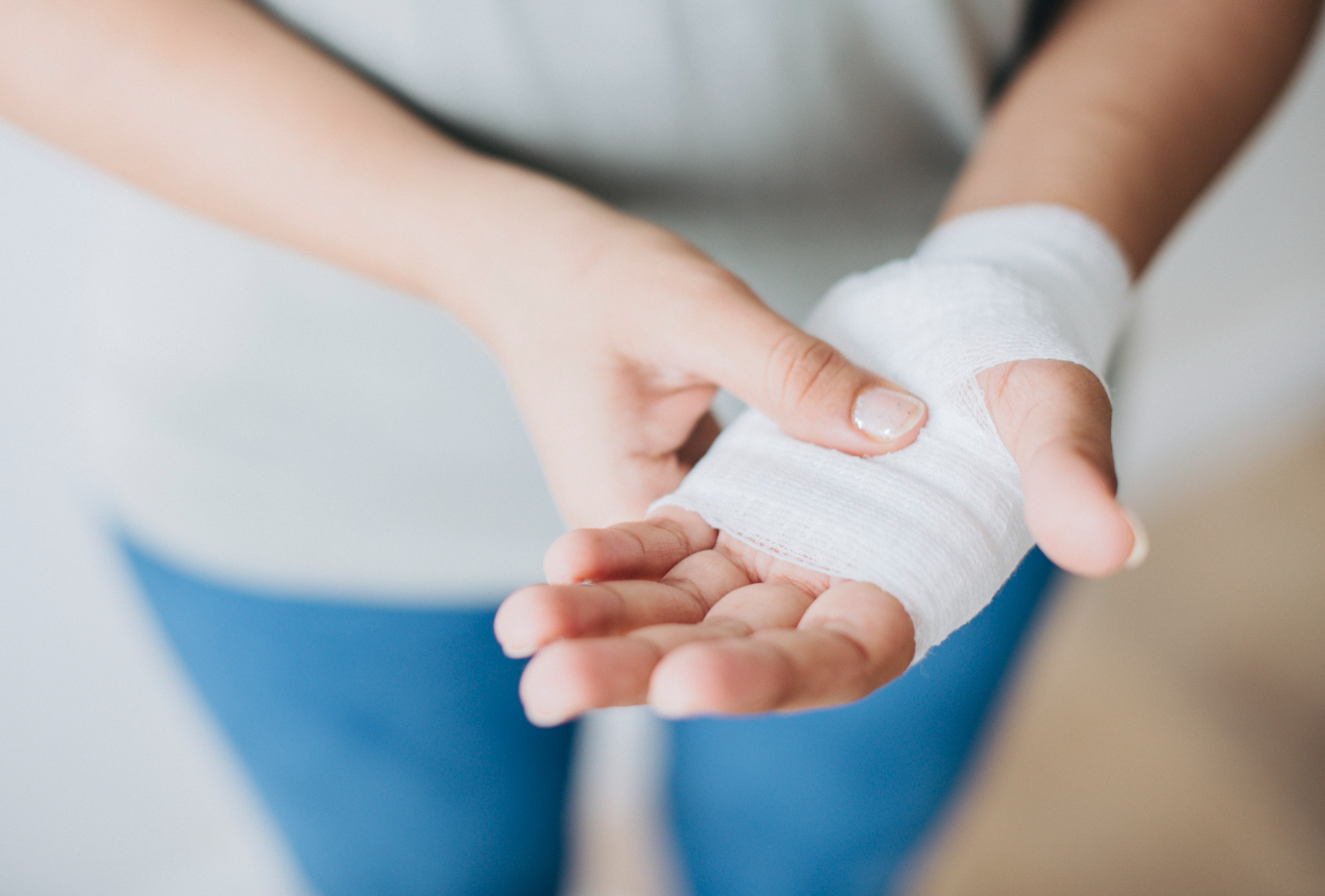 woman's hand with laceration and bandage woman's hand with laceration and bandage